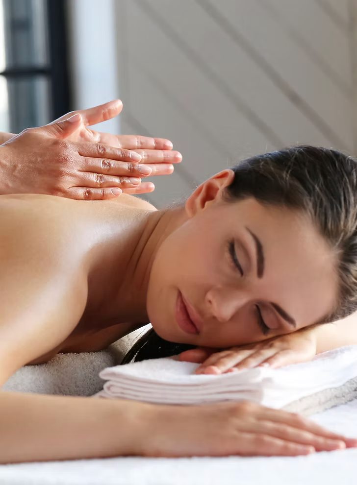 A back massage being given with slow, flat-handed pressure.